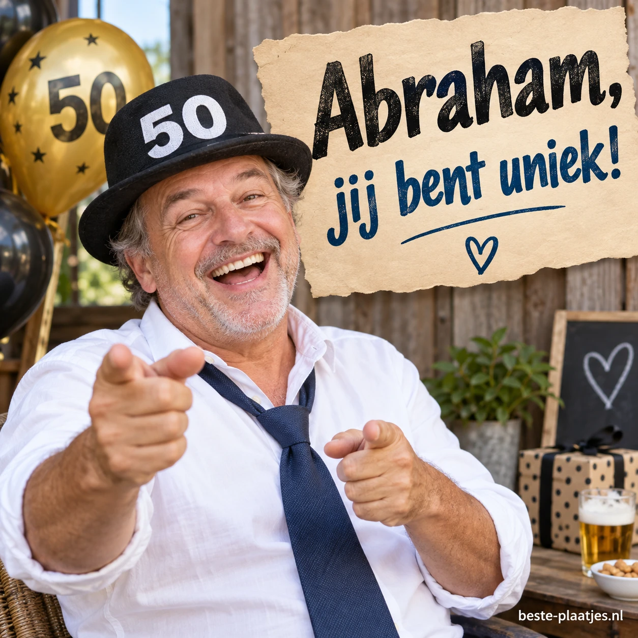 Een lachende Abraham wijst naar de jarige tussen ballonnen en cadeaus. Een lachende Abraham wijst naar de jarige tussen ballonnen en cadeaus.